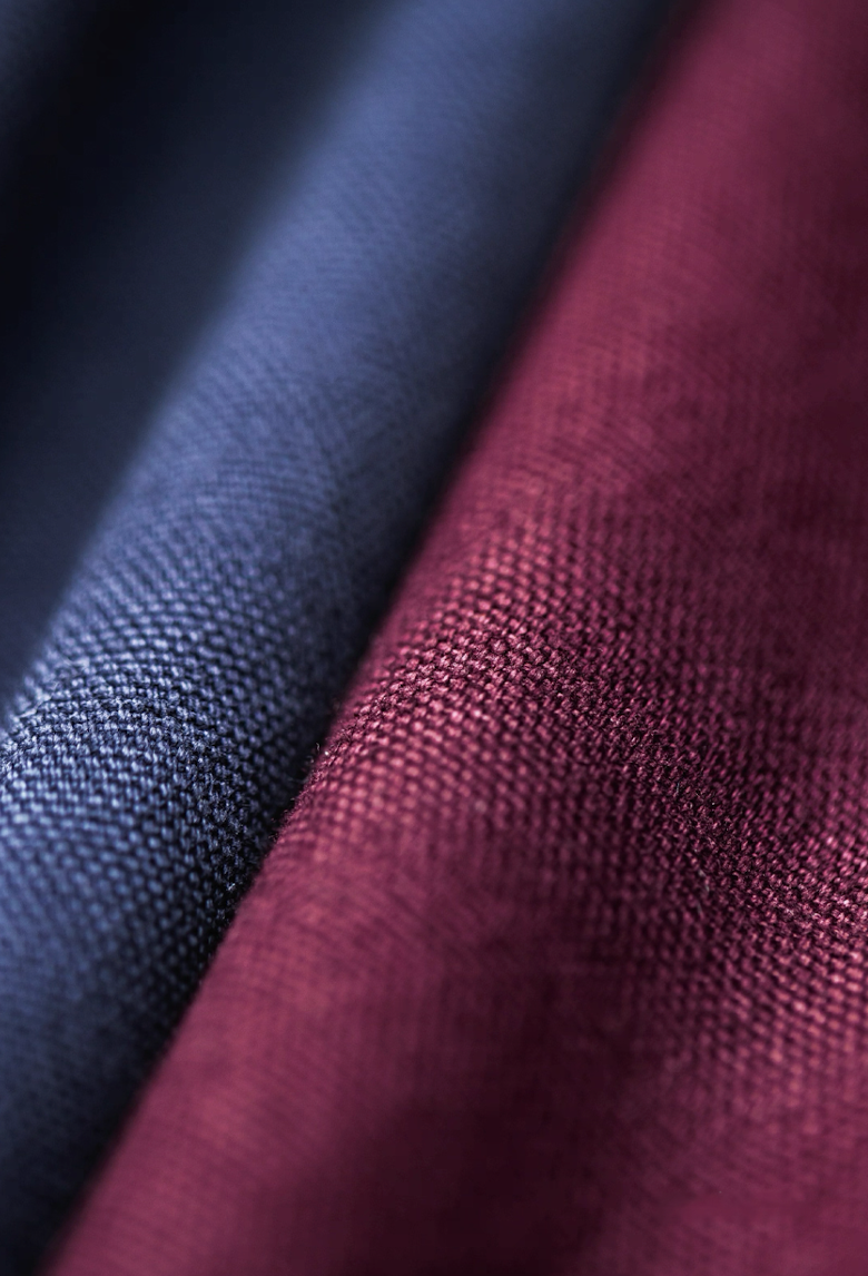 Fabric texture close-up of navy and burgundy Detroit work jackets