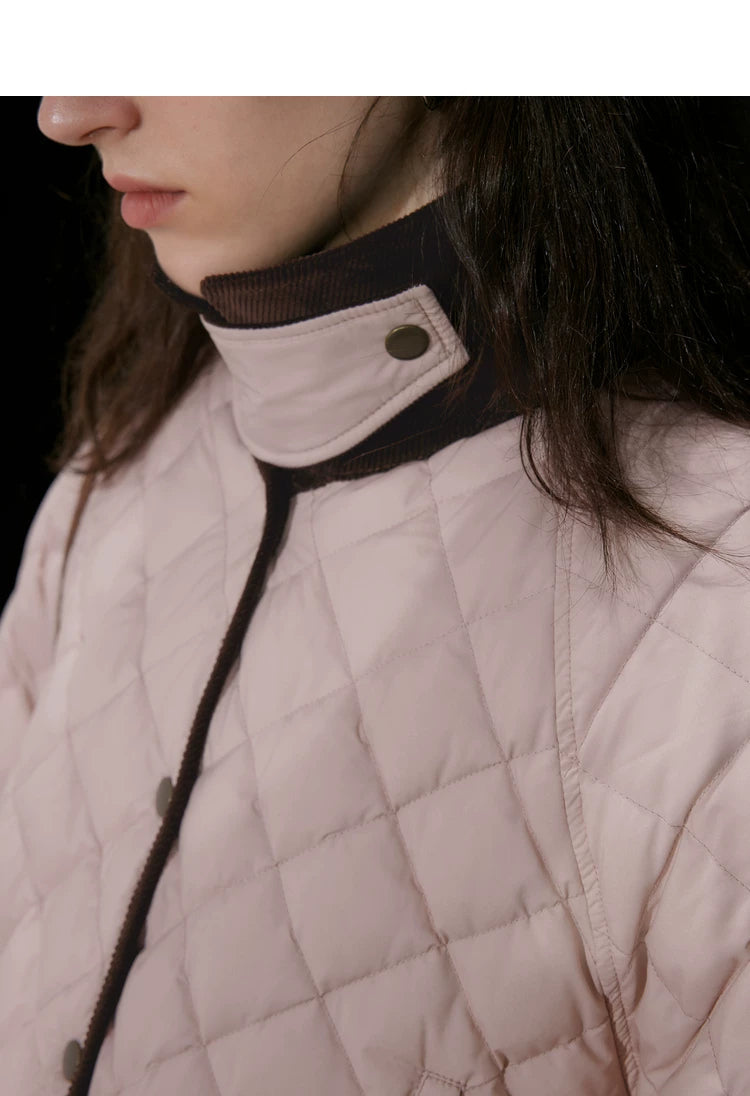 Close-up of brown corduroy collar with quilted snap tab and diamond quilting