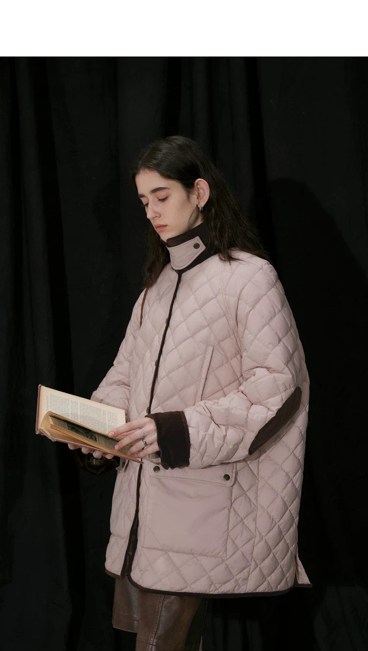 Side view of pink quilted barn coat with corduroy collar snapped up and turn-back cuffs
