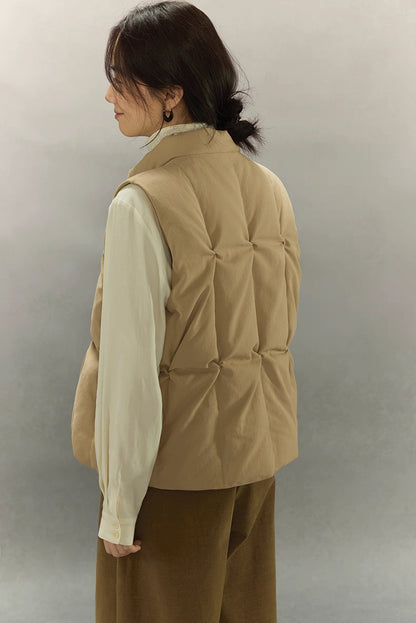 back view showing sculpted pinched quilting on beige down vest