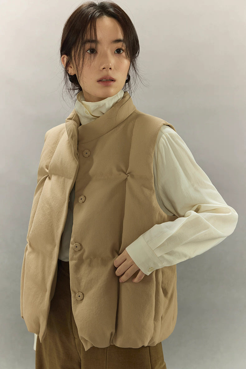 side view of woman in beige hollow-fiber insulated down vest