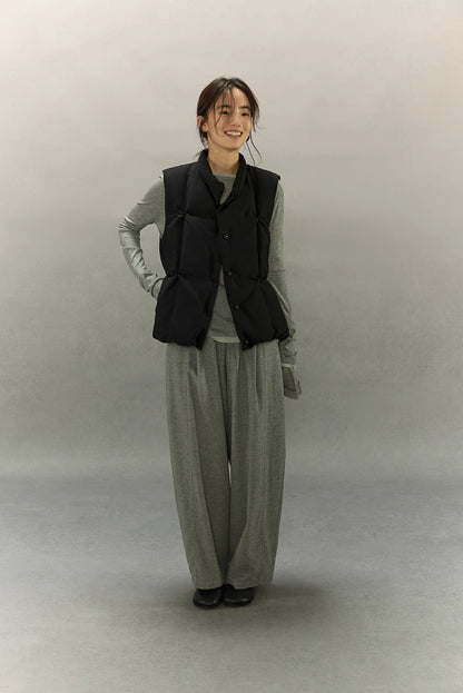 full-body view of woman in black lightweight down vest with grey set