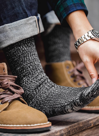 Close-up of Durable Cotton Crew Socks in black stretched on foot demonstrating flexible fit and soft ribbed cotton material