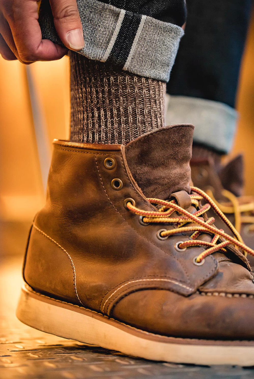 Close-up of Durable Cotton Crew Socks in brown paired with boots and rolled denim showcasing thick ribbed knit structure