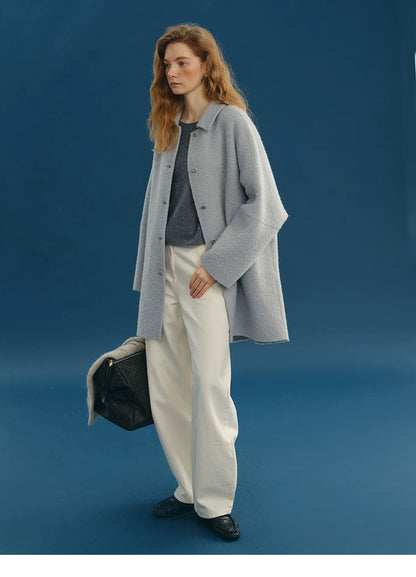 Dusty Blue double-faced coat worn open over a relaxed outfit, showing its boxy mid-thigh length