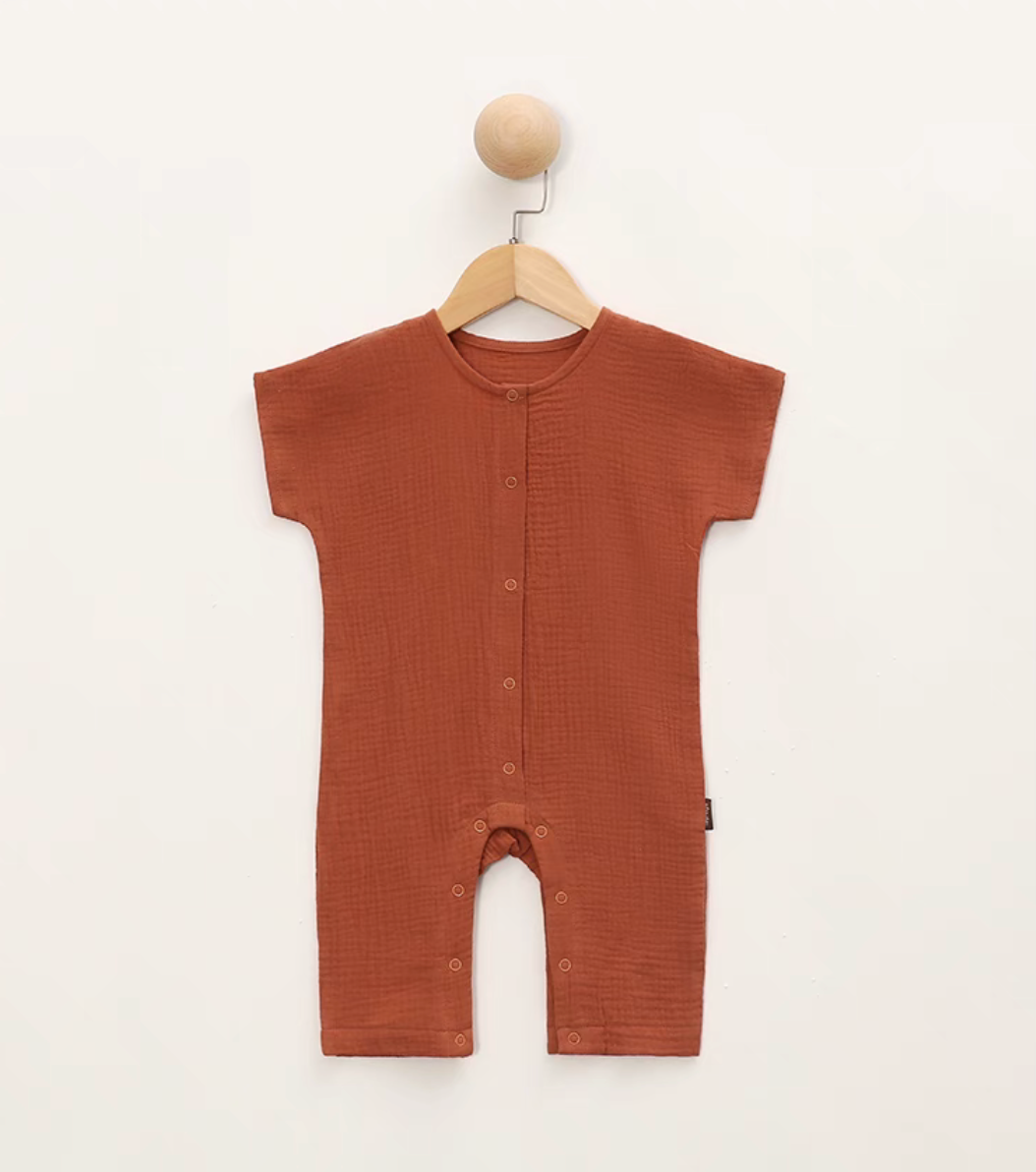 Orange red short sleeve baby romper hanging on hanger front view