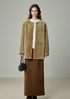 Full-length front view of camel round-neck shearling jacket with long rust skirt