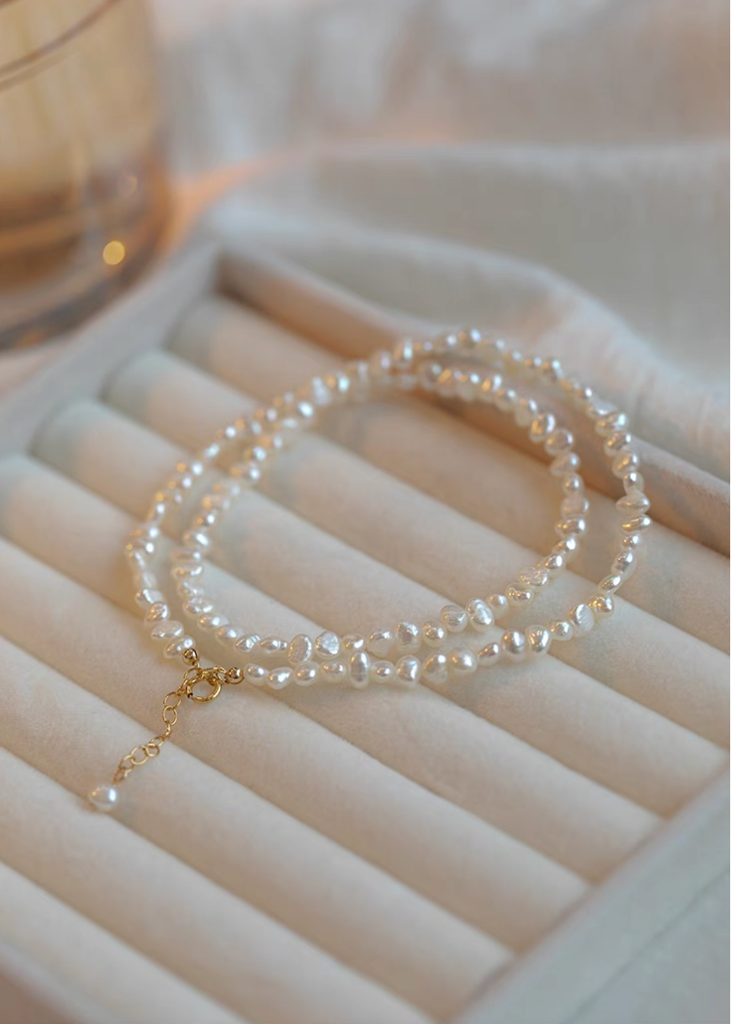 Elegant Irregular Freshwater Pearl Necklace with natural baroque mother of pearl beads coiled on jewelry tray