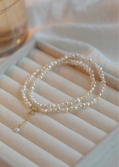 Elegant Irregular Freshwater Pearl Necklace with natural baroque mother of pearl beads coiled on jewelry tray