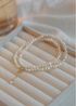 Elegant Irregular Freshwater Pearl Necklace with natural baroque mother of pearl beads coiled on jewelry tray