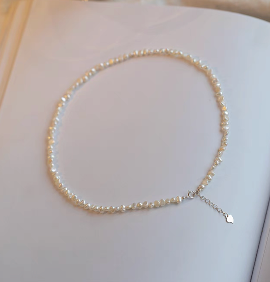 Elegant Irregular Freshwater Pearl Necklace with natural baroque mother of pearl beads full length flat lay