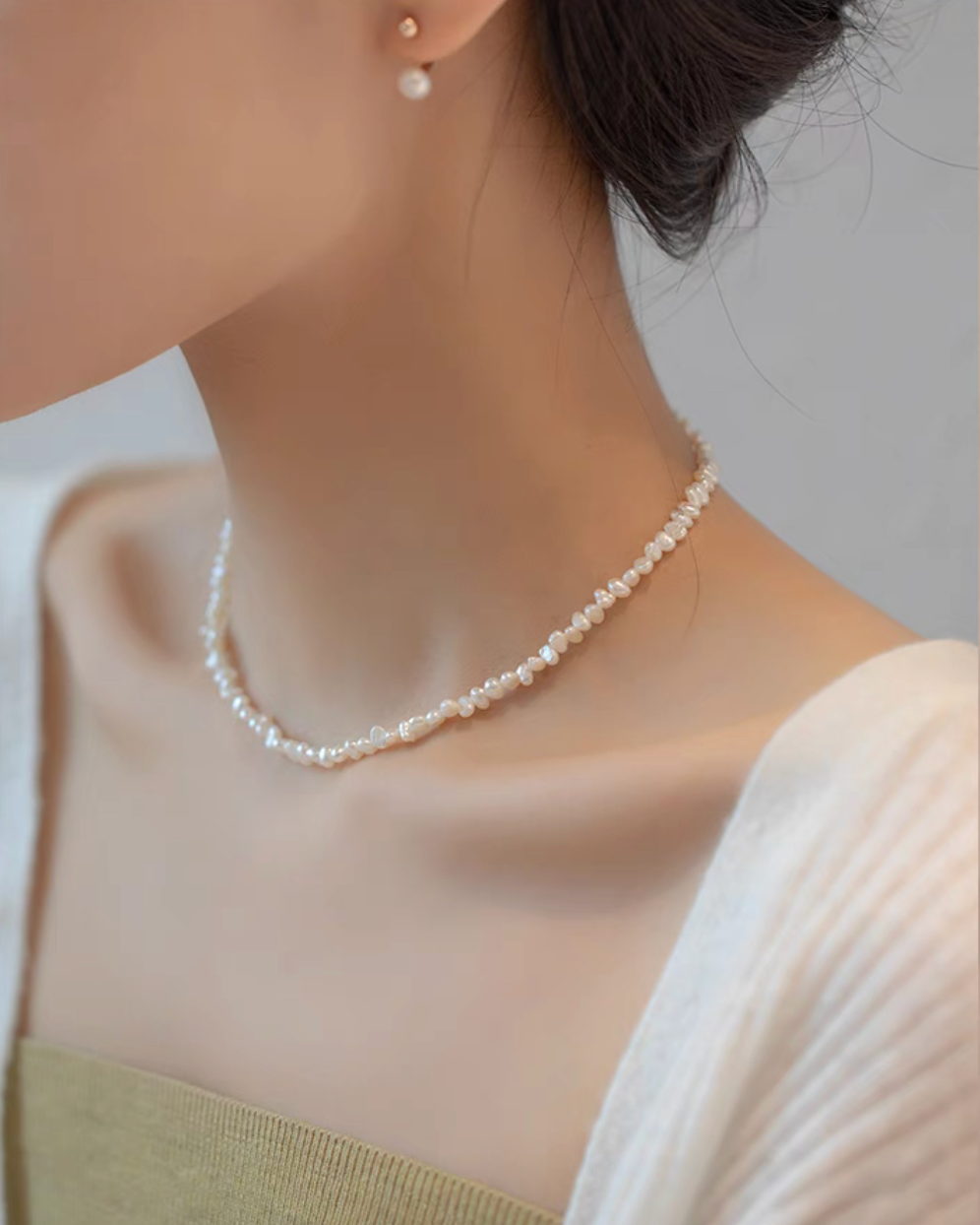 Side view of model wearing Elegant Irregular Freshwater Pearl Necklace with natural baroque mother of pearl beads