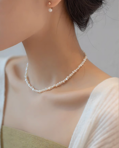 Side view of model wearing Elegant Irregular Freshwater Pearl Necklace with natural baroque mother of pearl beads