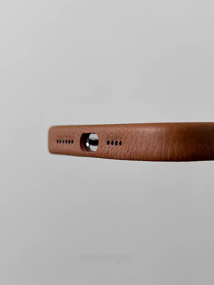 Bottom view of brown leather MagSafe phone case with accurate charging port and speaker cutouts