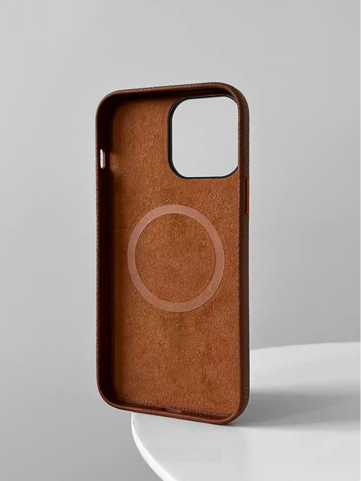 Interior of brown leather MagSafe phone case showing built-in MagSafe ring and soft lining