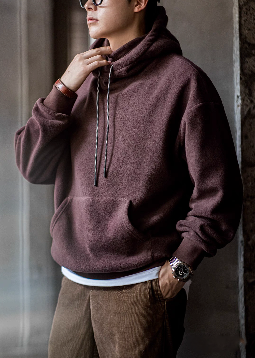 Close-up of Elevate Shield Hoodie in chestnut red highlighting semi-high collar, drawstring hood, and soft fleece texture
