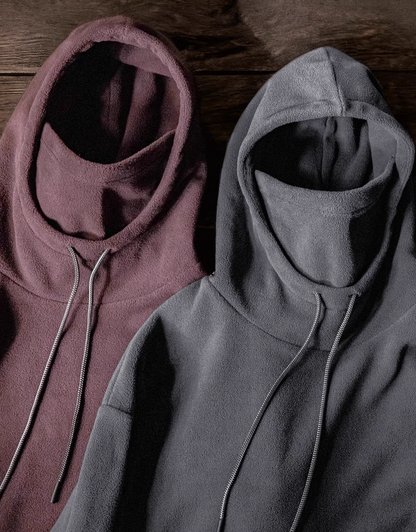 Elevate Shield Hoodie in dark gray and chestnut red displayed side by side showing fleece texture, visor hood, and integrated face guard design