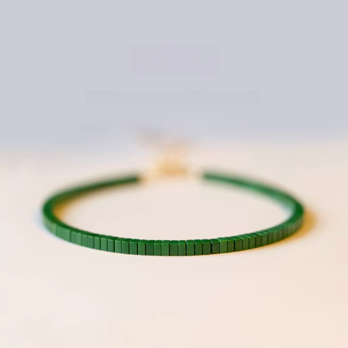 Emerald Essence minimalist bracelet in moss green with flat square malachite beads on a clean background