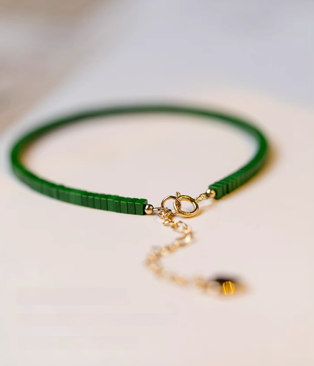 Close-up of seaweed green malachite bracelet highlighting gold clasp and bead finishing detail
