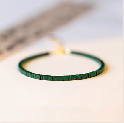 Emerald Essence bracelet in deeper seaweed green tone with flat malachite beads on minimal surface