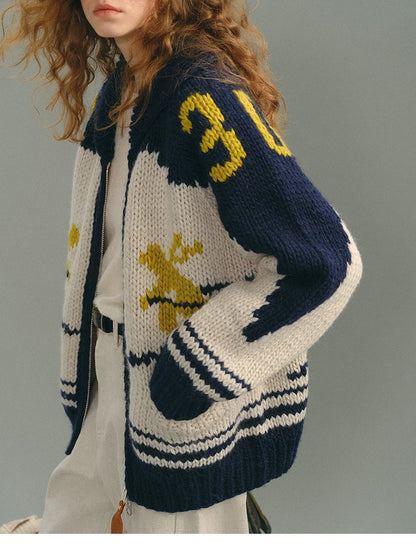 Close-up of navy multi Fair Isle wool cardigan sleeve and pocket detail
