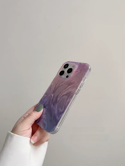 Gradient purple feather pattern phone case angled view with glossy texture and slim protective fit