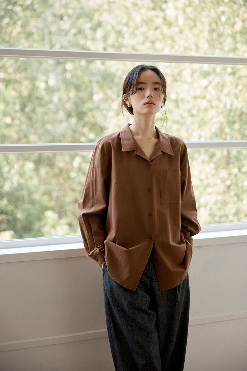 Woman wearing brown Flex-Weave long-staple cotton button-up shirt front view, showcasing relaxed fit, spread collar, and smooth cotton drape