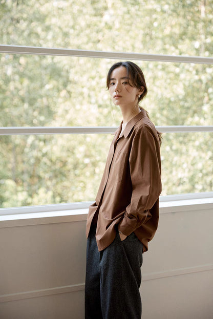 Side angle view of brown Flex-Weave cotton shirt showing relaxed fit, chest pocket detail, and soft breathable fabric
