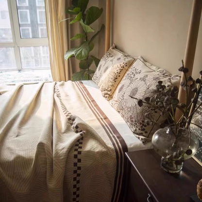 Floral Cotton Gauze Blanket Elegant Splendor displayed on a bed near a window with elegant botanical bedding