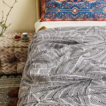 Floral Cotton Gauze Blanket Leaf Vein featuring black leaf vein pattern spread across a bedroom bed