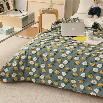 Gray Daisy fleece throw blanket covering bed with daisy pattern design
