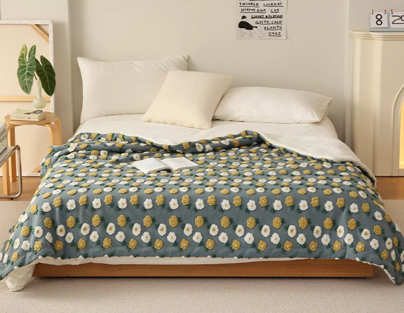 Gray Daisy fleece throw blanket styled neatly across bed in modern room