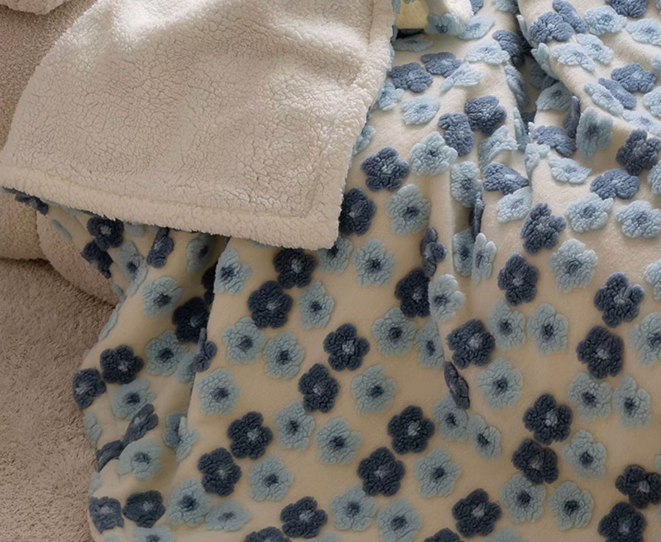 Close-up of Jacquard Blue floral fleece blanket showing raised jacquard texture