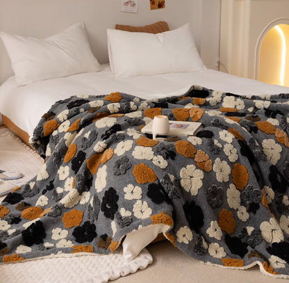 Jacquard Gray floral fleece throw blanket laid across bed in neutral bedroom