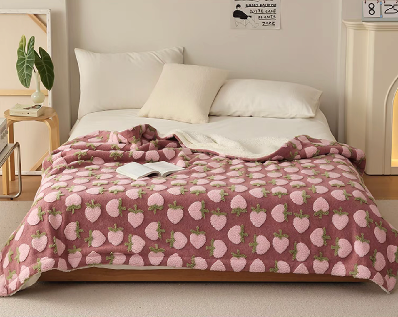 Peach fleece throw blanket styled across bed with decorative pillows