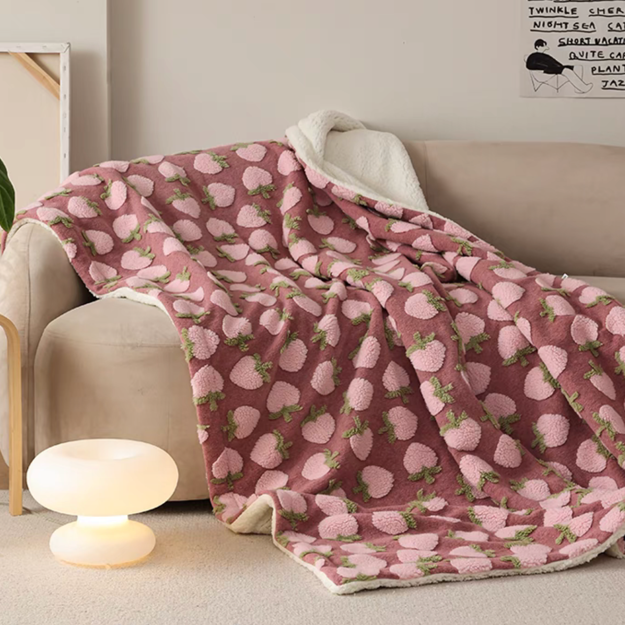 Peach fleece throw blanket draped over sofa with warm ambient lighting