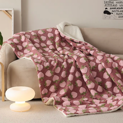 Peach fleece throw blanket draped over sofa with warm ambient lighting