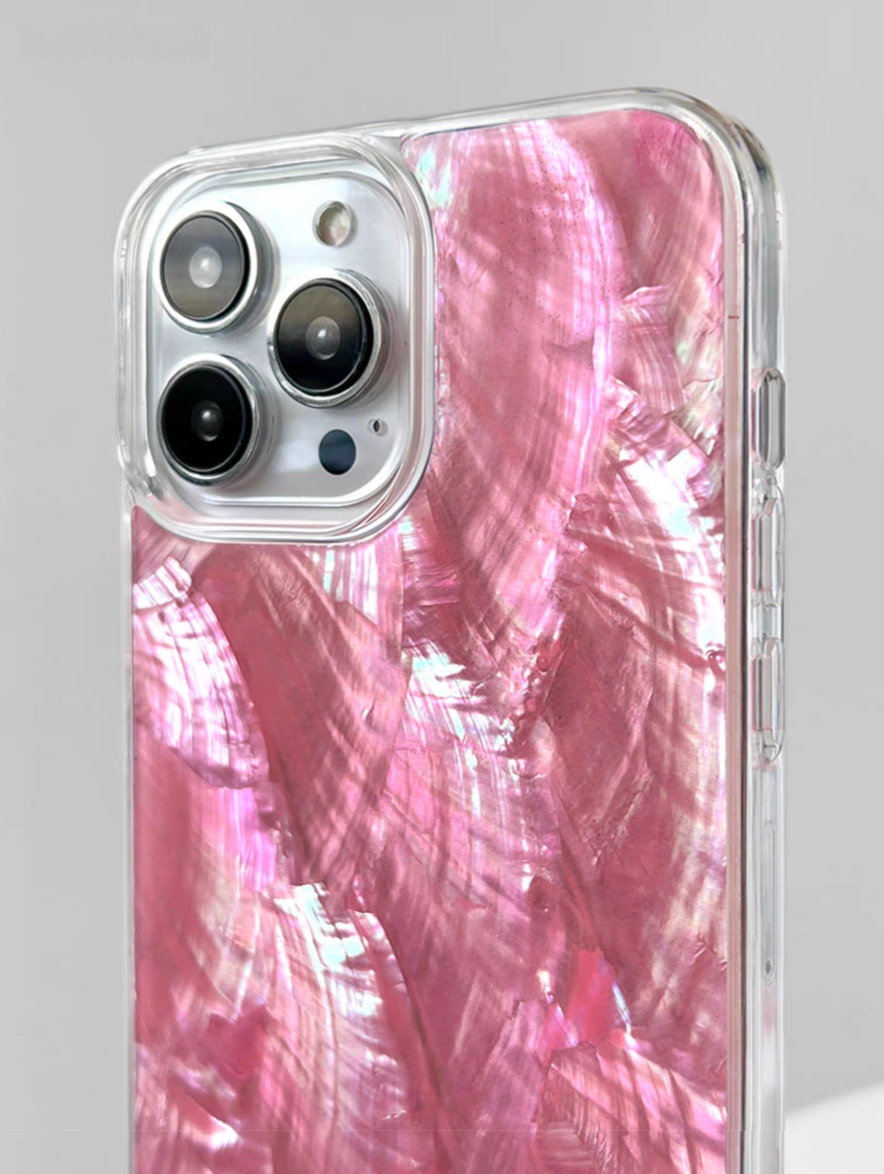 Close-up of pink mother-of-pearl shell phone case with reflective shell finish and camera cutout detail