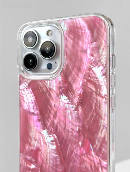 Close-up of pink mother-of-pearl shell phone case with reflective shell finish and camera cutout detail