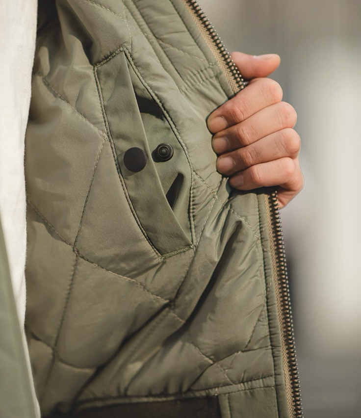 Close-up of inner quilted lining and snap pocket detail of the MA-1 bomber.