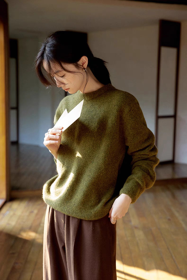 Cardamom green brushed wool sweater in close-up view highlighting soft fuzzy texture and relaxed crewneck design