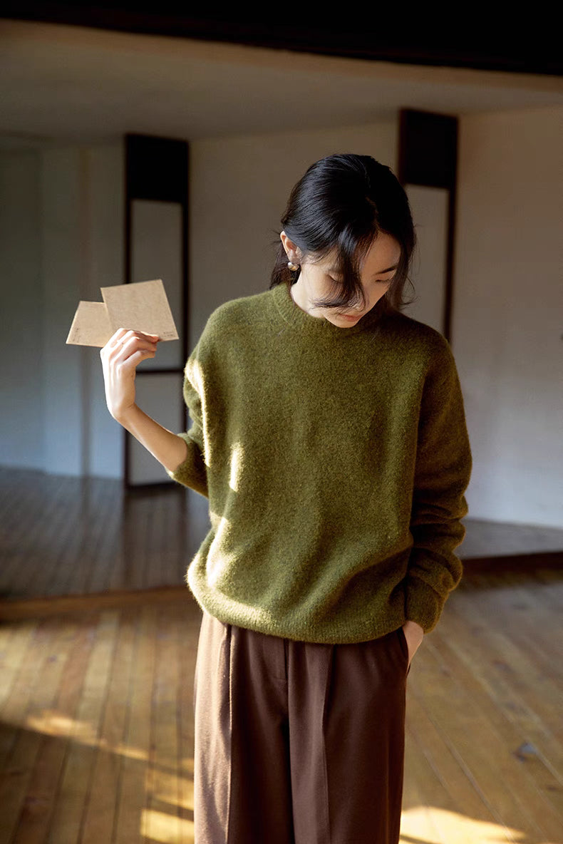 Cardamom green brushed wool sweater worn in natural light showing cozy oversized fit and smooth drape