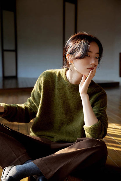 Cardamom green brushed wool sweater styled in seated pose highlighting soft texture and casual comfort