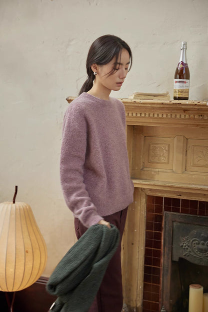 Cloud purple brushed wool sweater styled near fireplace highlighting soft knit and everyday elegance