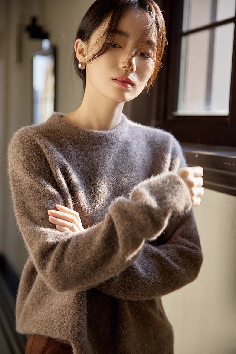 Coffee brown brushed wool sweater in close-up view highlighting soft fuzzy texture and relaxed fit near window