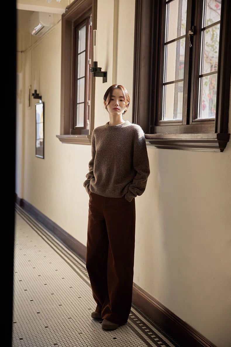 Full outfit view of coffee brown brushed wool sweater styled with wide-leg pants in hallway setting