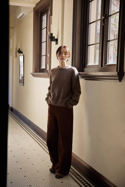 Full outfit view of coffee brown brushed wool sweater styled with wide-leg pants in hallway setting