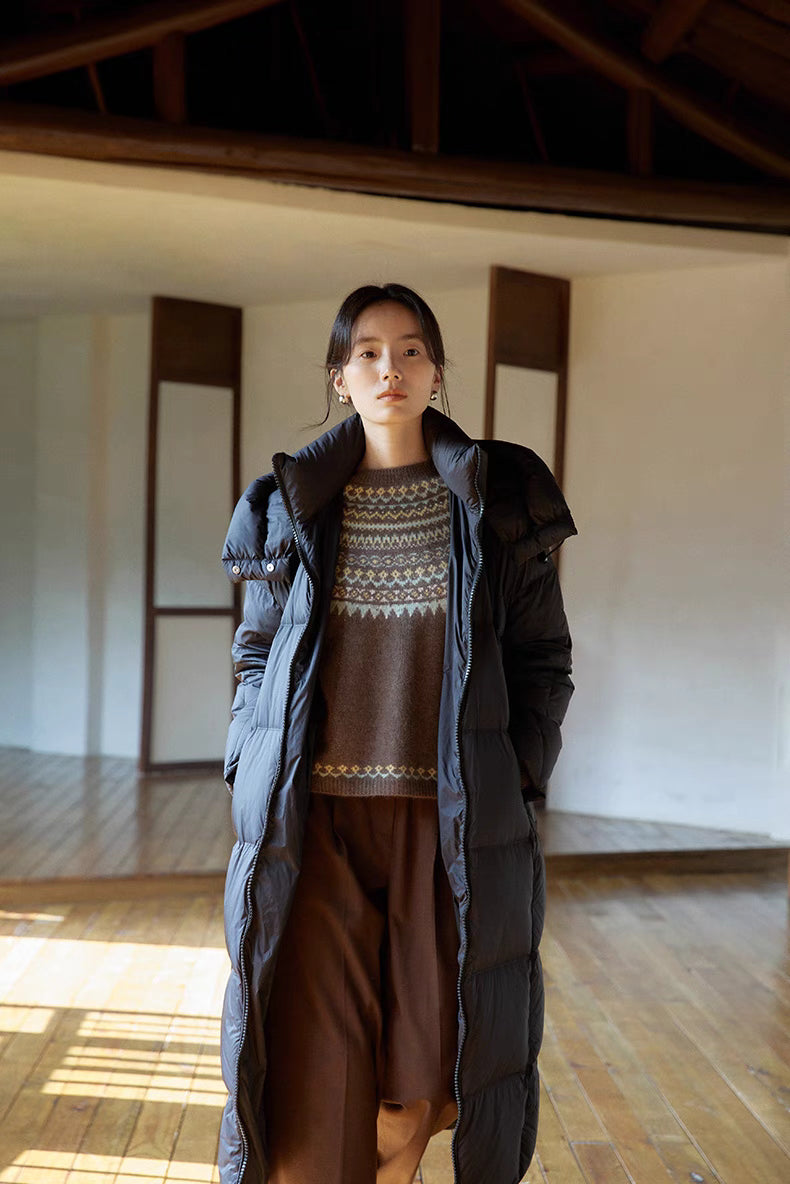 Model layering smoky brown Frosted Peaks Fair Isle Sweater under black puffer coat highlighting winter styling and cozy warmth