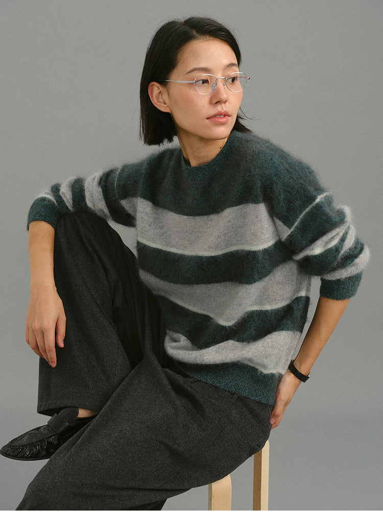 model sitting while wearing dark green gray striped brushed sweater