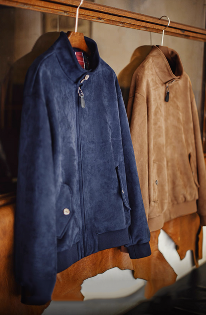 Navy suede Harrington jacket hanging on wooden hanger